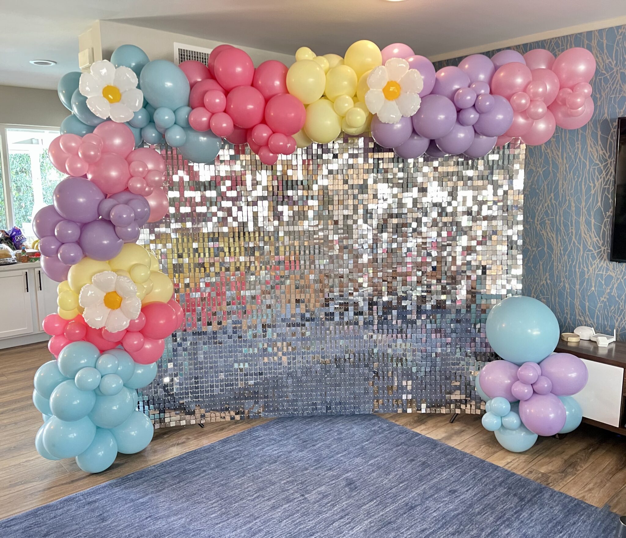 Balloon backdrop with greenery and florals